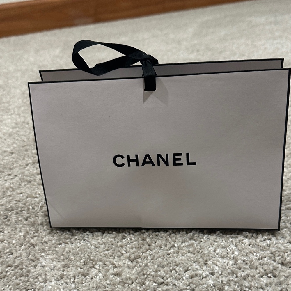 Chanel White Gift Bag with Black Ribbon and stuffing.